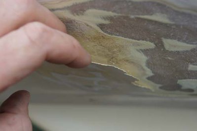Damaged gel coat layer peeling already from the inner hull glass structure, with air gap in between
